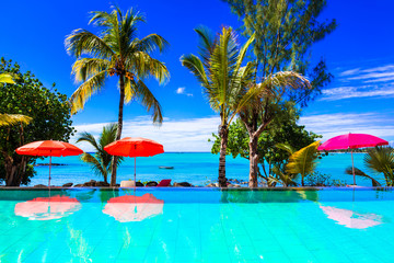 Tropical vacation - turquoise swim pool with sea view. Mauritius island