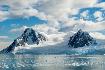 Glacier carved snow capped mountains in Antarctica.