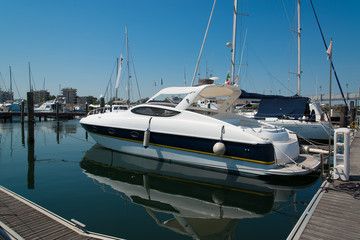 Fototapeta premium White yachts in the port waiting. On the sea is calm.