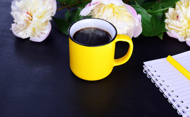 Hot black coffee in a yellow mug