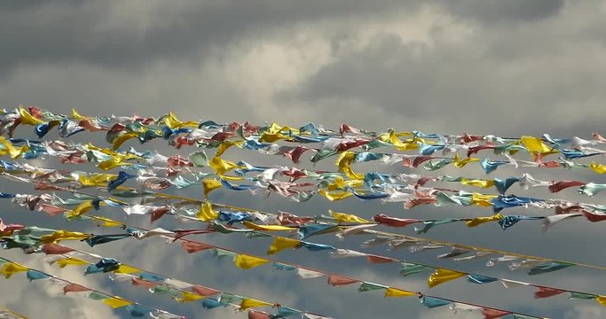 4k prayer flag in wind,clouds background.