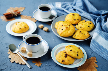 Chocolate chips pumpkin cookies with cups of coffee