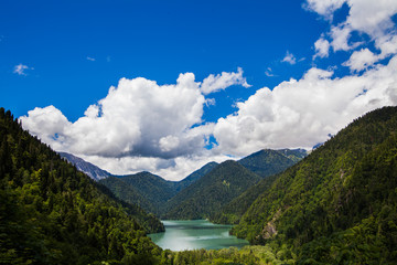 Fototapeta na wymiar Alpine lake Ritsa among the mountains covered with forest
