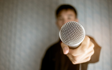 blurred of businessman speech talking and reporter with microphone at presentation in conference...
