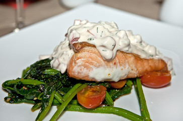 A delicious steak of salmon with lettuce in green vegetables