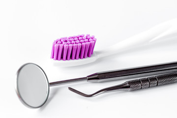 dental care toothbrush with dentist tools on white background