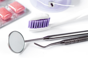 dental care toothbrush with dentist tools on white background