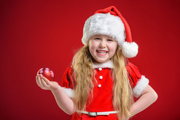 Little beautiful girl dressed as Santa Claus gifts dealer.
