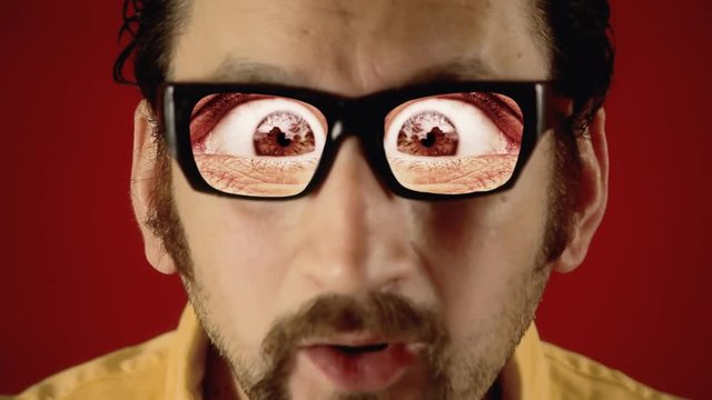 A funny ugly man with hypnotic glasses, showing big painful eyes. Weirdness, surreal, dream.
