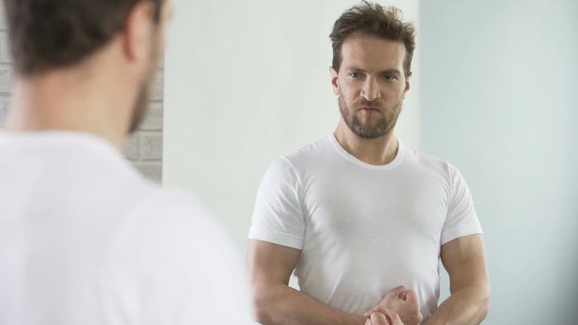 Selfish macho admiring and flirting with his reflection, self-improvement