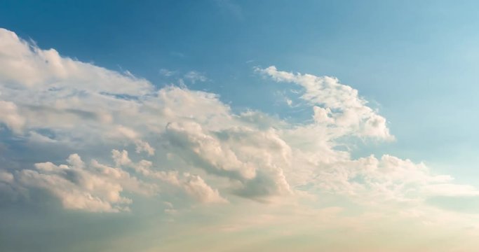 Time lapse clip of evening fluffy curly rolling clouds