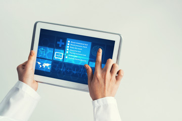 Close of female doctor hands working with tablet pc computer
