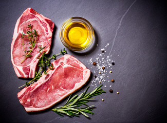 Two raw veal chops with ingredients