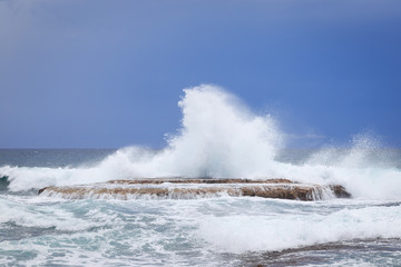 Waves crashing on rock