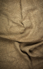 Burlap, natural coarse cloth, tablecloth with folds