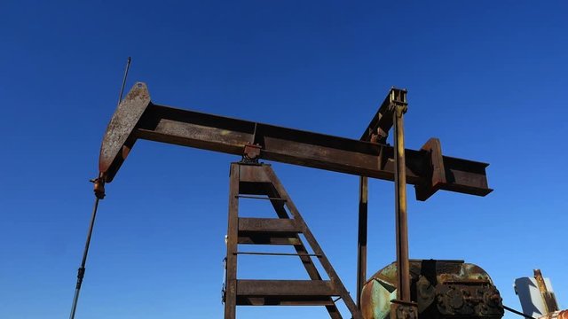 Close up of a pump jack at an oil well