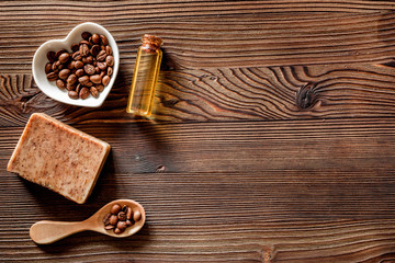 Homemade skin care. Coffee soap on wooden background top view copyspace