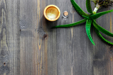 Skin care. Aloe vera gel and aloe vera leafs on wooden background top view copyspace