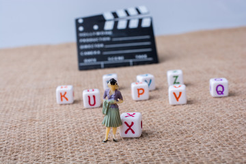 Letter cubes beside a director clapper board