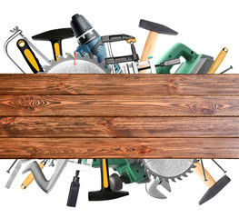 Set of carpenter's tools and wooden board on white background