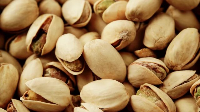 Food background. Roasted pistachio nuts seed with shell close up. Dieting concept. Dolly slider shot 4K ProRes HQ codec