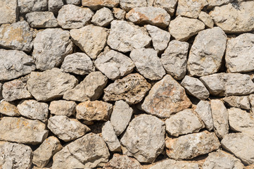 Detail of an old stone wall in Palma de Mallorca on a sunny day