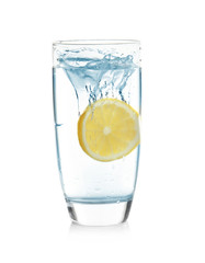 Glass of lemonade with splashing water on white background