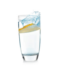 Glass of lemonade with splashing water on white background