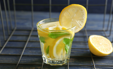 Glass of fresh lemonade on table