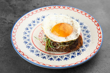 Delicious breakfast with sunny side up egg on table