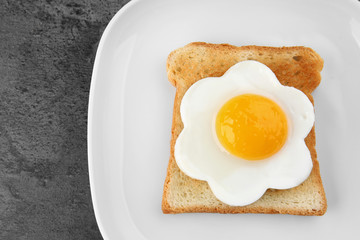 Plate with delicious sunny side up egg and toast, closeup