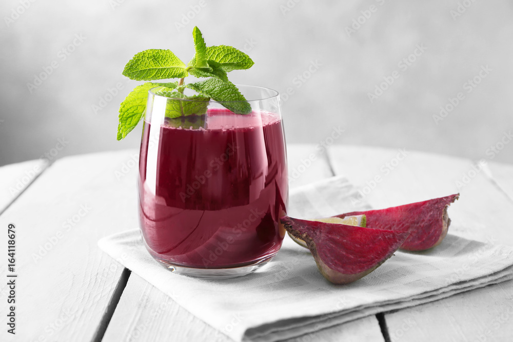 Poster glass of fresh homemade smoothie with mint on table