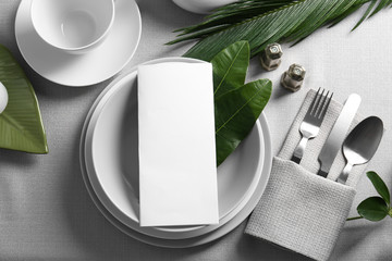 Beautiful table setting with green tropical leaves