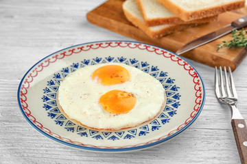Homemade over easy fried eggs on plate