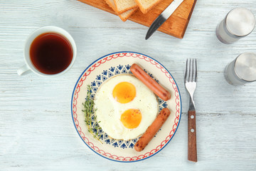Homemade over easy fried eggs with sausages on plate