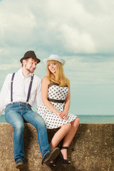 Loving couple retro style dating on sea coast