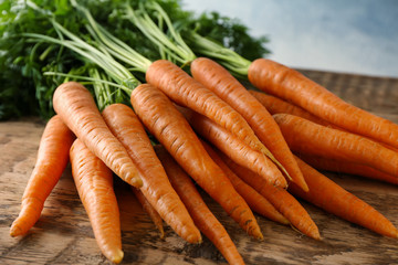 Fresh organic carrots on wooden table