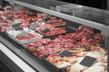 Fresh meat in cooled display in supermarket