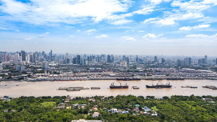 Obraz premium Aerial View of Bangkok skyline and view of Chao Phraya River View from green zone in Bang Krachao, Phra Pradaeng, Samut Prakan Province.