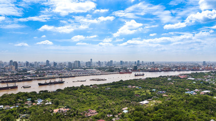 Obraz premium Aerial View of Bangkok skyline and view of Chao Phraya River View from green zone in Bang Krachao, Phra Pradaeng, Samut Prakan Province.