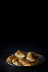 Homemade Qatayef on Dark Background with Copy Space Top Vertical