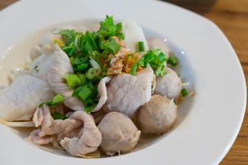 Boiled pork, meat ball, fish ball, fish with spring onion and  deep fried garlic.