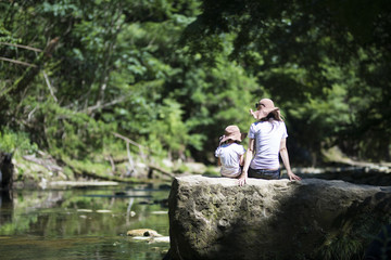 Mother and daughter playing in mountain stream