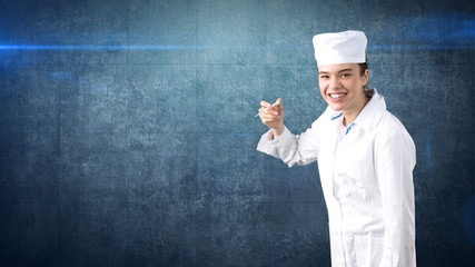 Naklejka premium Beautiful medical woman doctor in uniform. Studio painted background. Concept of profitable health care.