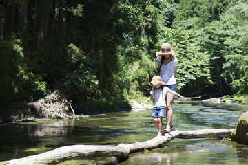 Mother and daughter playing in mountain stream