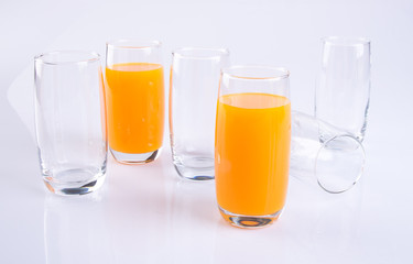 Orange juice in glasses on white background.