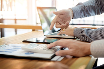 Fototapeta premium Team work process. young business managers crew working with new startup project. laptop on wood table, typing keyboard, texting message, analyze graph plans