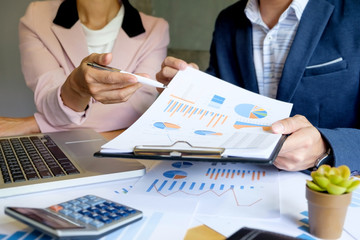 Team work process. young business managers crew working with new startup project. labtop on wood table, analyze graph plans