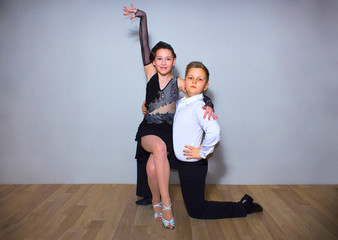 The young boy and girl posing at dance studio