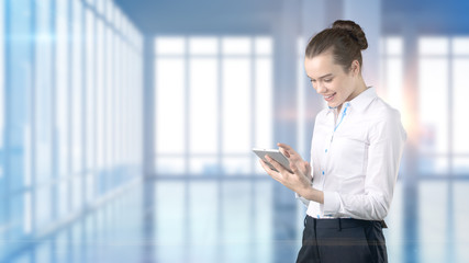 Fototapeta premium Young beautiful business woman and creative designer standing over blured interior background